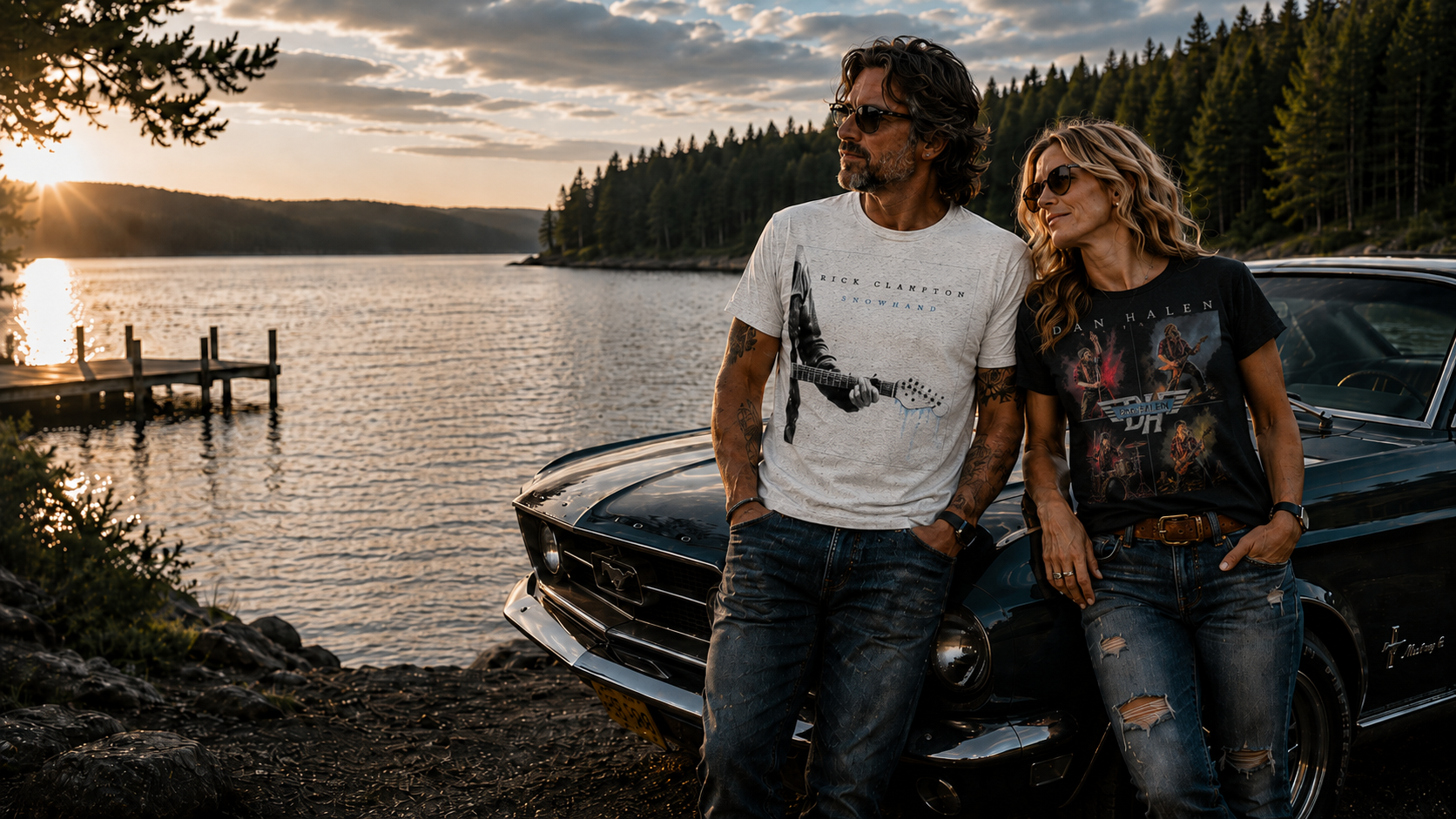 Two people sitting by a car by a lake at sunset